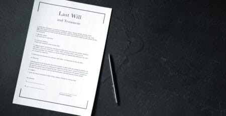 Last Will and Testament document with a pen on a dark table