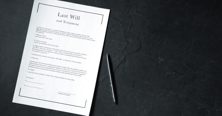 Last Will and Testament document with a pen on a dark table
