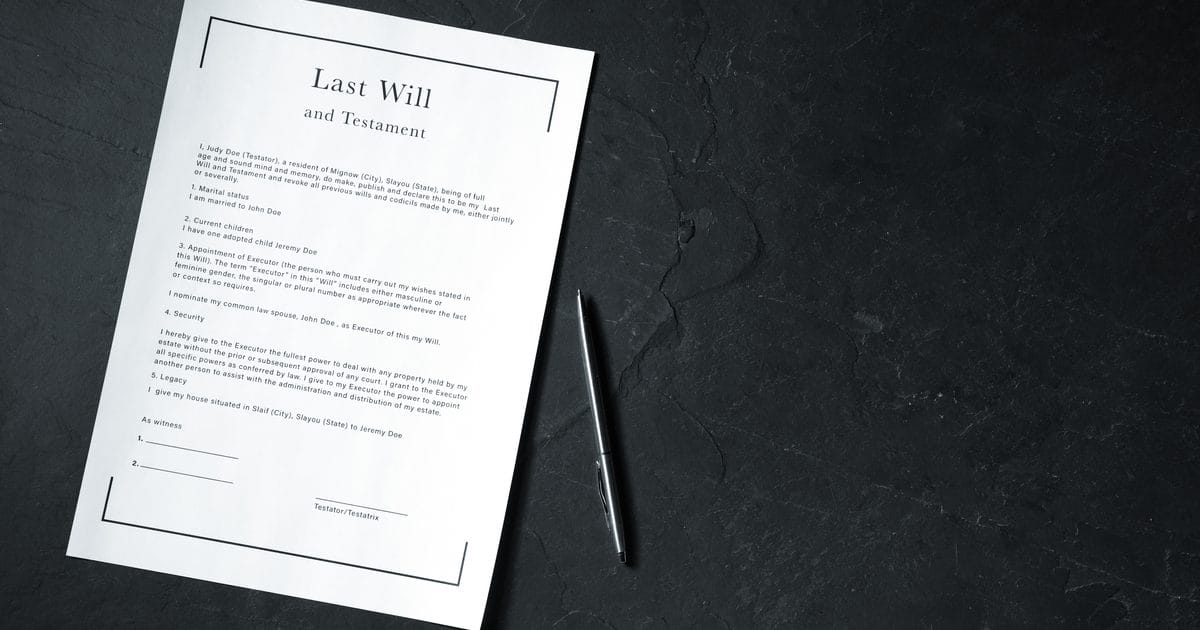 Last Will and Testament document with a pen on a dark table